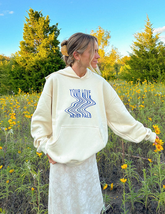 Love Never Fails Cream Unisex Hoodie – Christian Hoodie