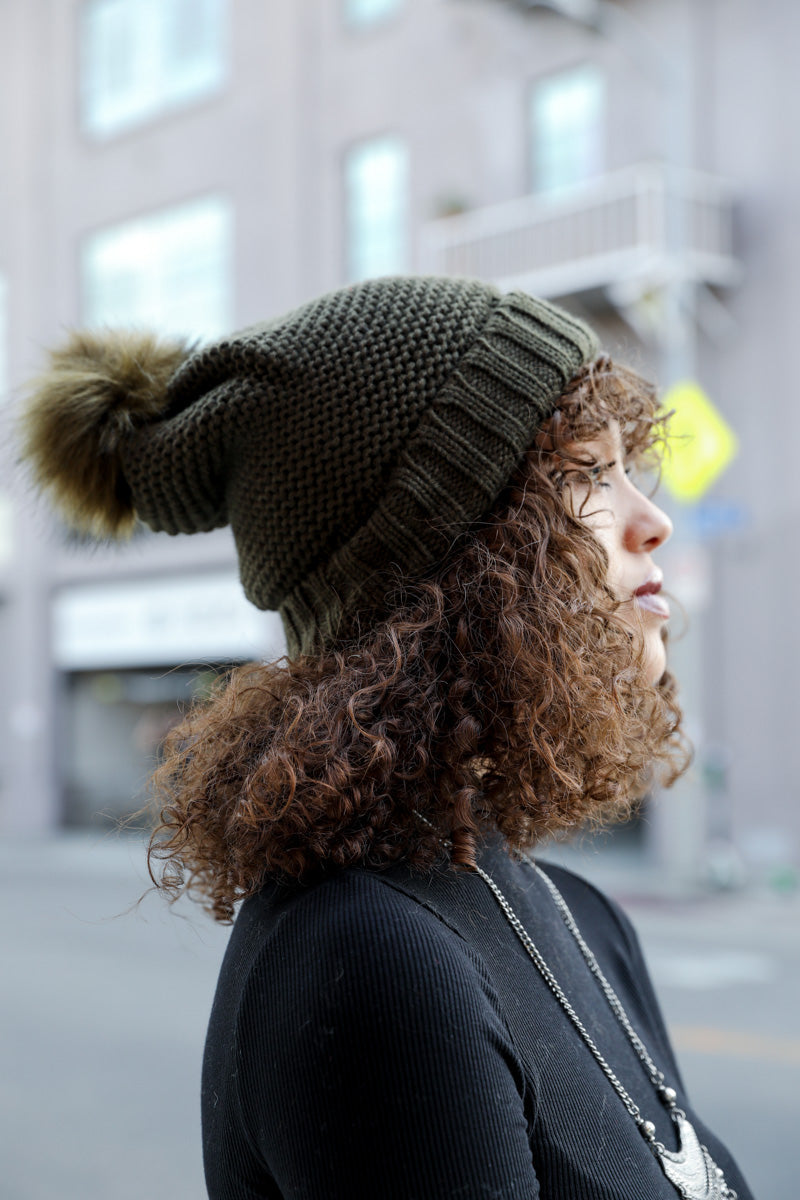 Olive green Pom Beanie by Leto Collection with cozy Faux Sherpa lining, perfect for winter warmth.