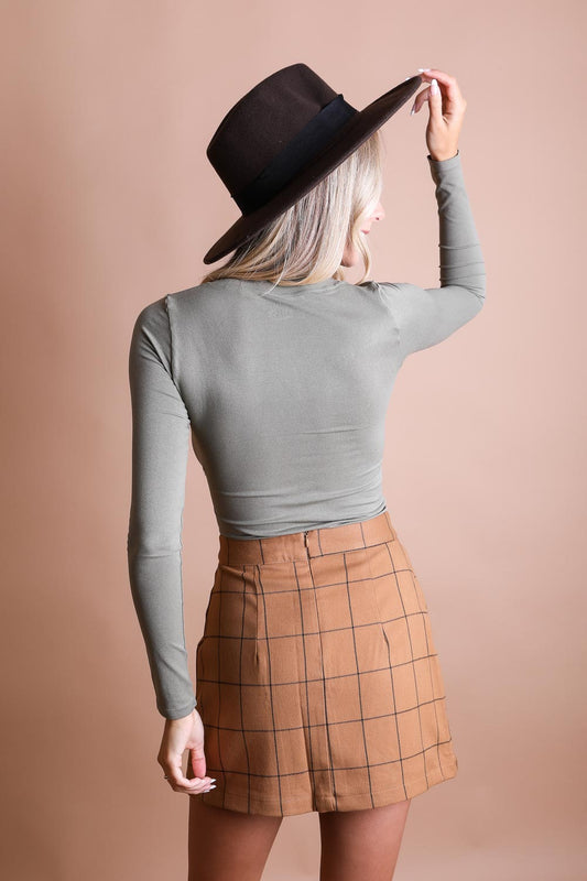 Olive green long sleeve fitted crop top from Leto Collection, showcasing a close-up of the stylish, snug design and fabric texture.