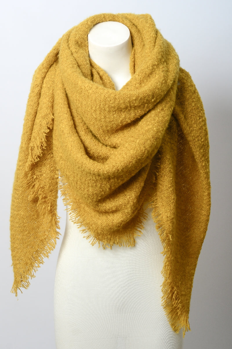 Mustard Leto Collection mohair square blanket scarf displayed folded with soft, cozy fabric and stylish fringe edges.