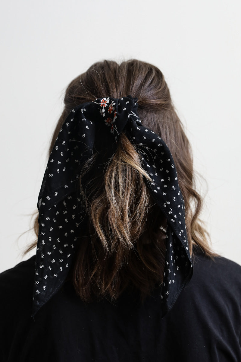 Black dotted and floral bandana by Leto Collection, showcasing a stylish fabric with a vibrant floral pattern and dotted design.