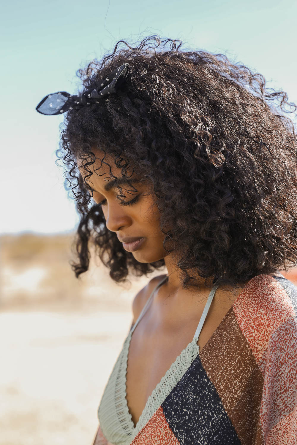 Black dotted and floral bandana by Leto Collection featuring vibrant patterns and lightweight fabric.