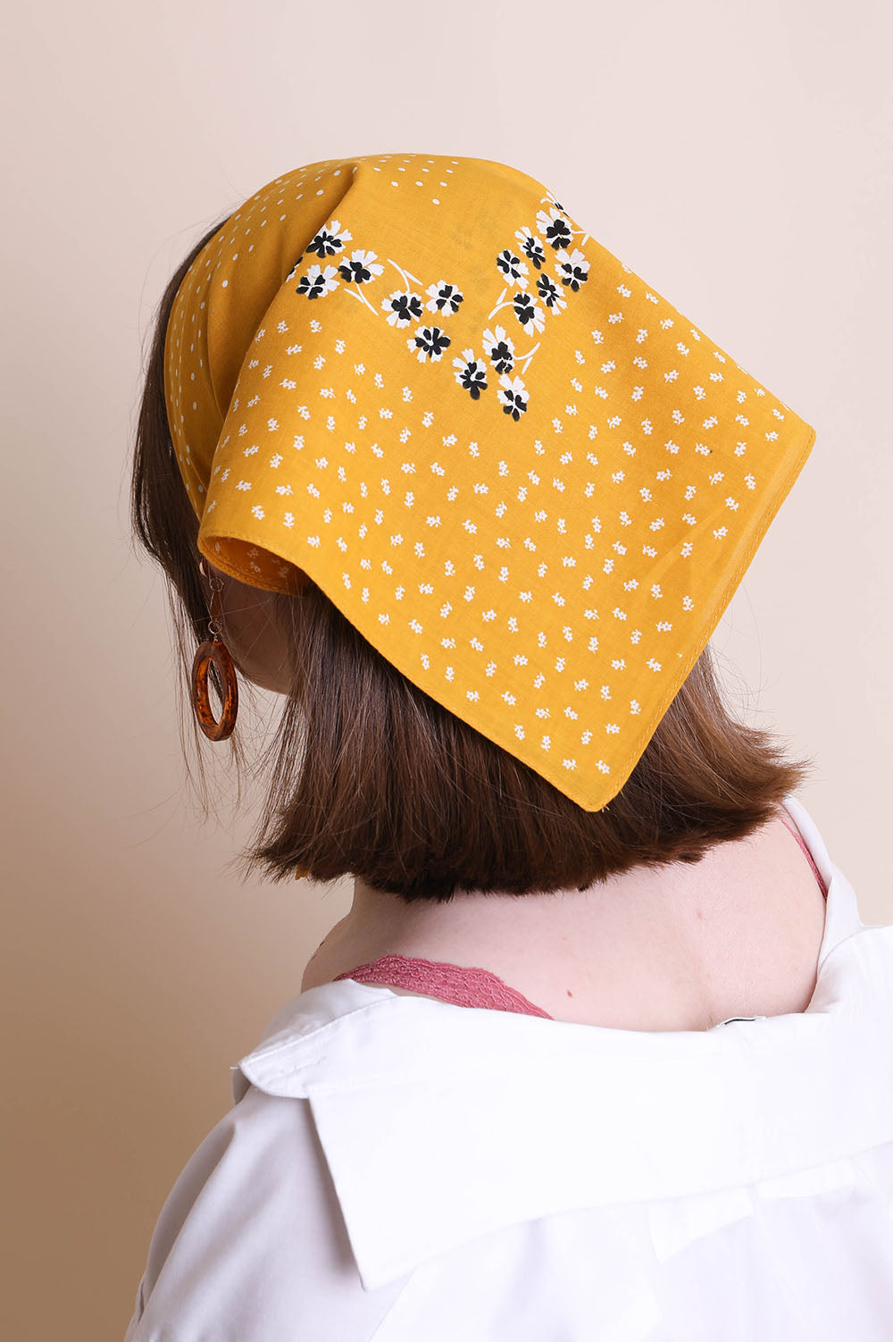 Yellow dotted and floral bandana by Leto Collection featuring vibrant patterns and lightweight fabric.