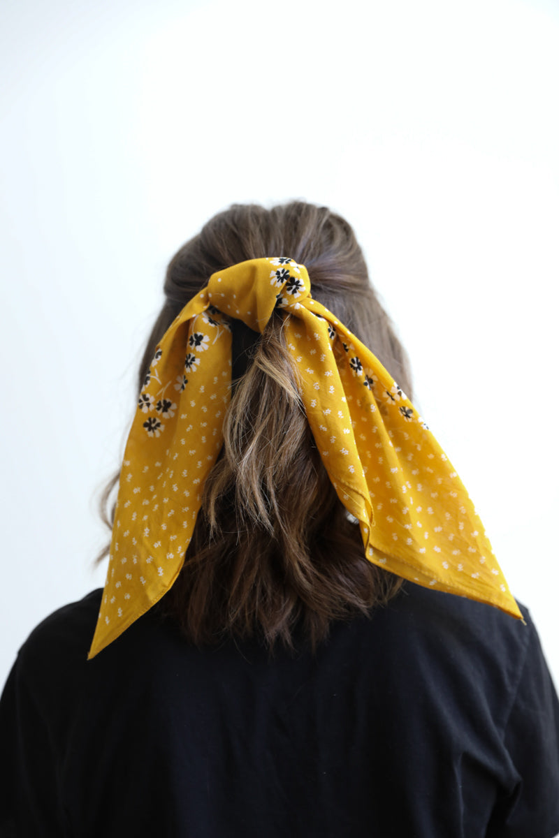 Yellow dotted and floral bandana from Leto Collection, featuring vibrant patterns and soft fabric for stylish accessory wear.