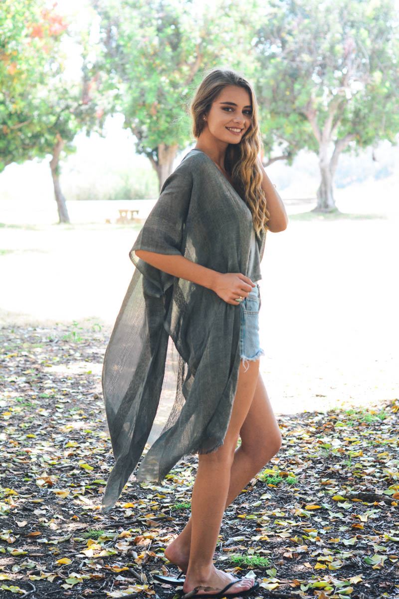 Charcoal woven long line tribal kimono by Leto Collection displayed hanging with intricate woven patterns and flowing fabric