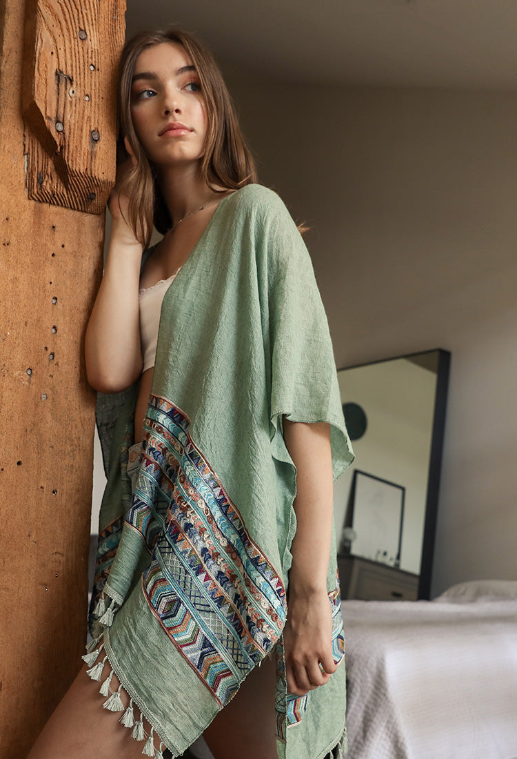 Embroidered geometric kimono by Leto Collection featuring intricate patterns and lightweight fabric, displayed on a hanger.