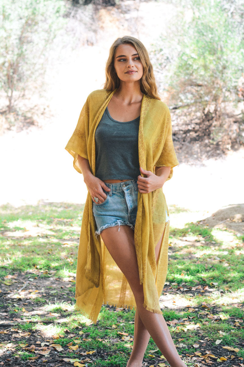 Mustard woven long line tribal kimono by Leto Collection, featuring intricate patterns and flowing fabric.