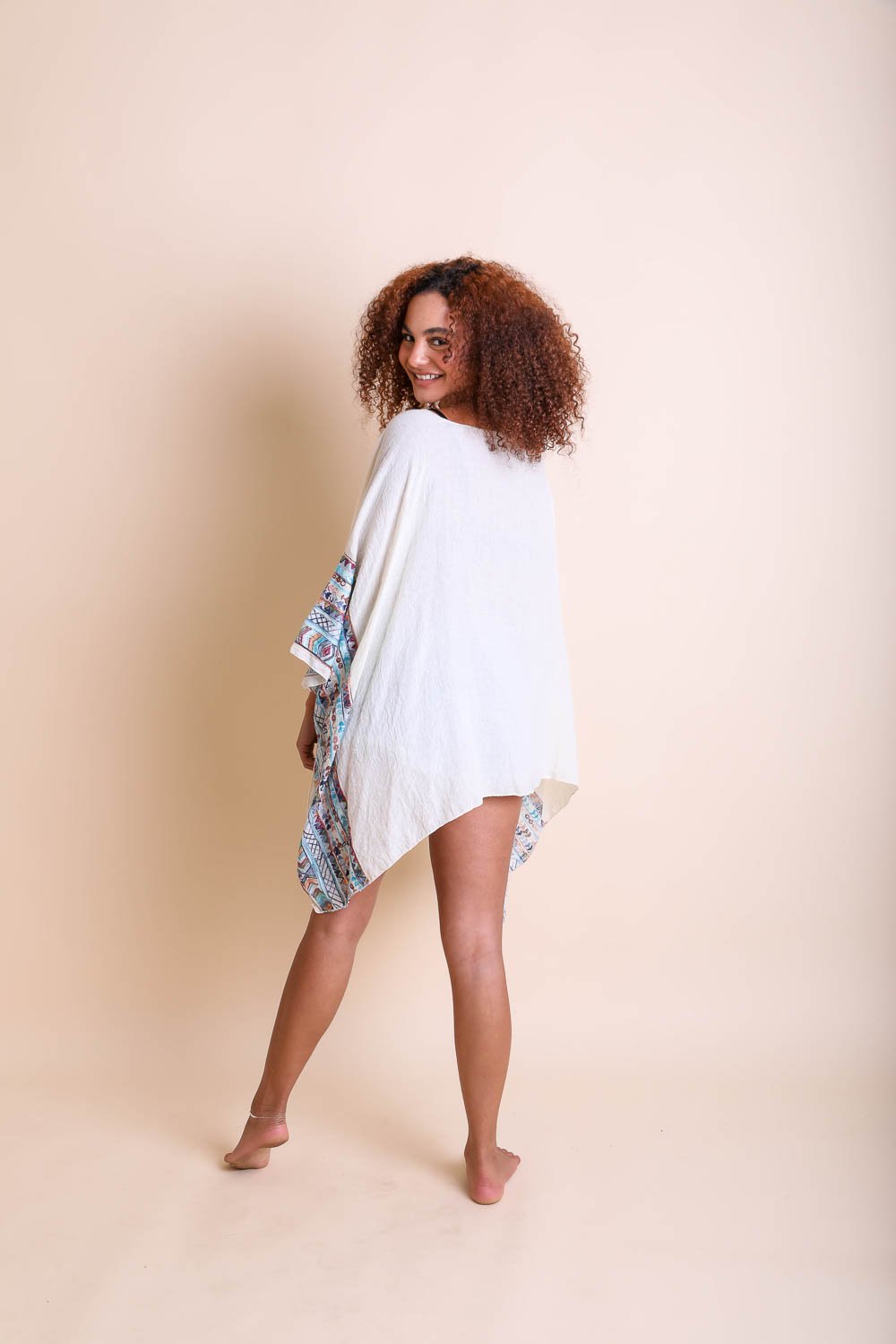 Leto Collection geometric embroidered kimono tunic with colorful patterns and flowing fabric, styled for casual wear.
