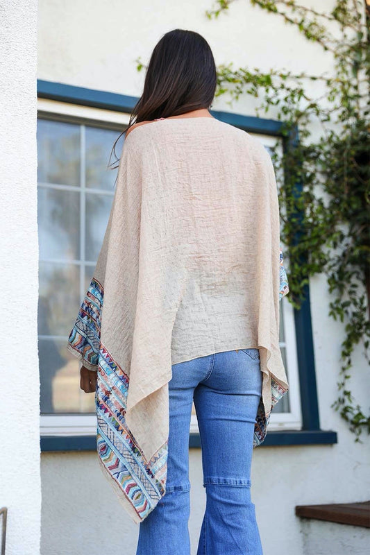 Leto Collection geometric embroidered kimono tunic with colorful patterns and flowy fabric, displayed on a hanger.