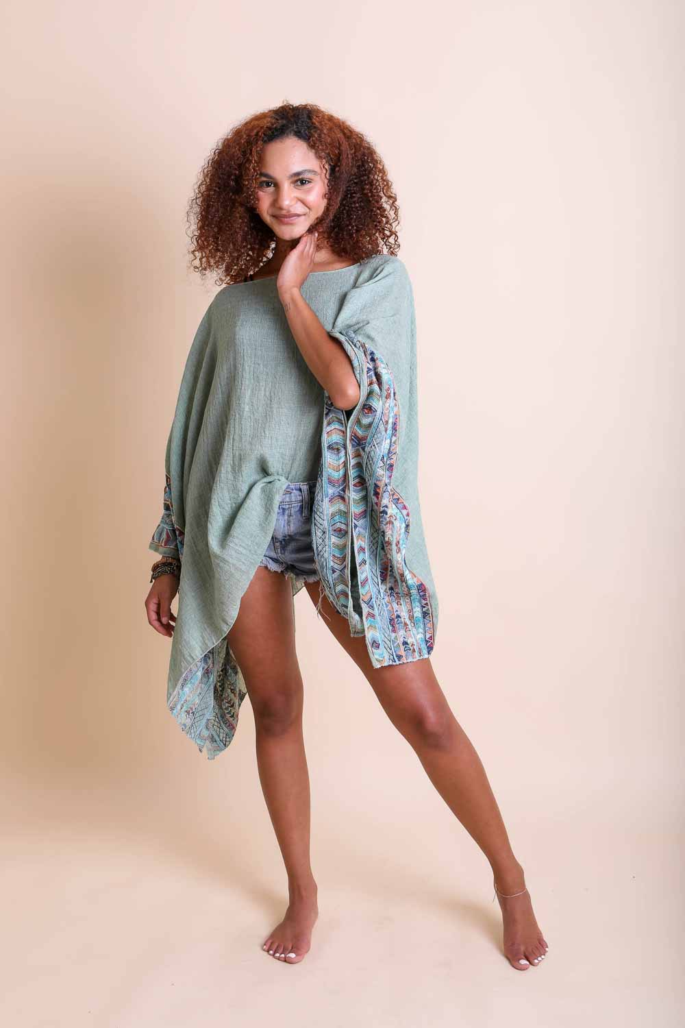 Leto Collection geometric embroidered kimono tunic with colorful patterns and intricate stitching, displayed on a hanger.