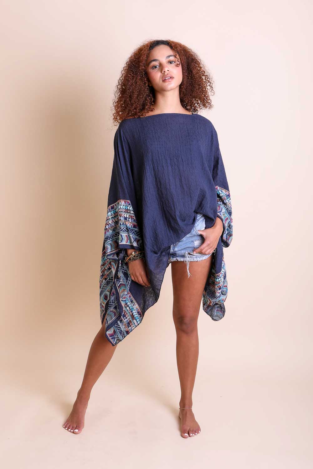 Leto Collection geometric embroidered kimono tunic with colorful patterns and lightweight fabric, displayed on a hanger.